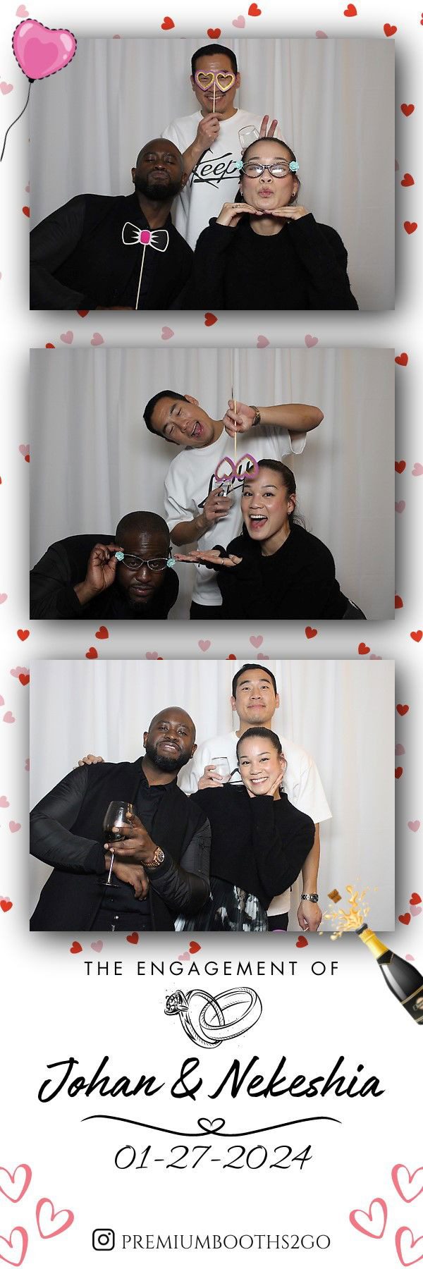 Three friends posing playfully in a photo booth with heart decorations.