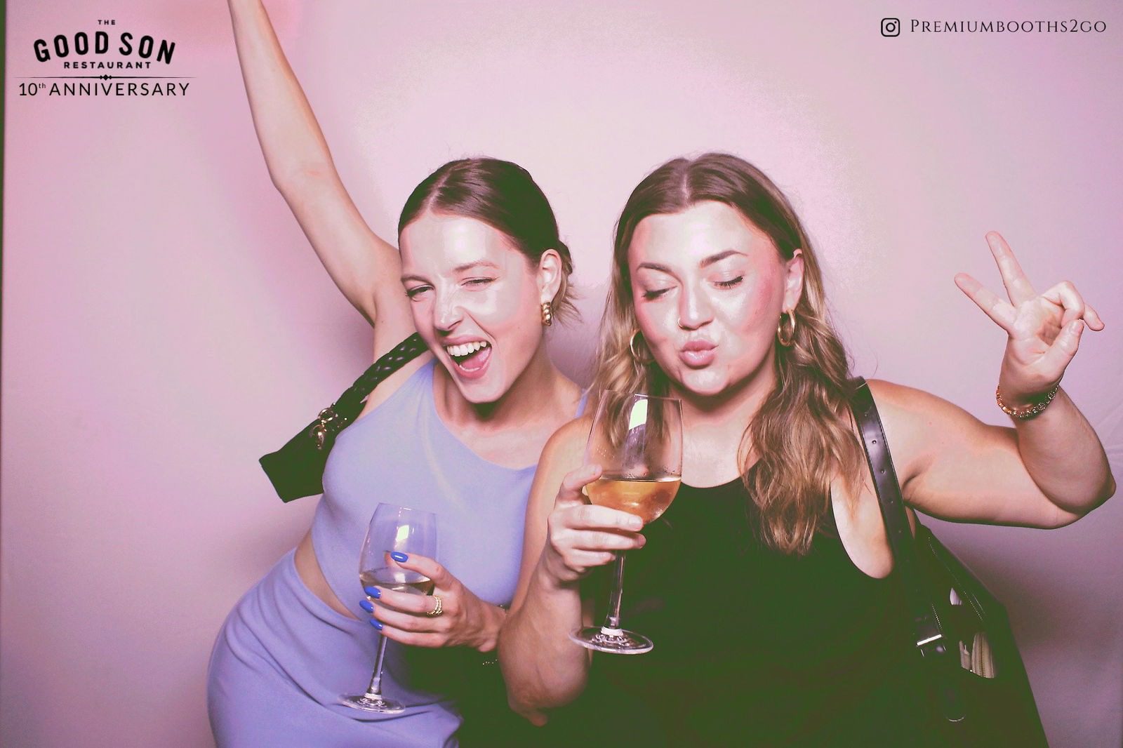 Two women enjoying drinks and celebrating together.