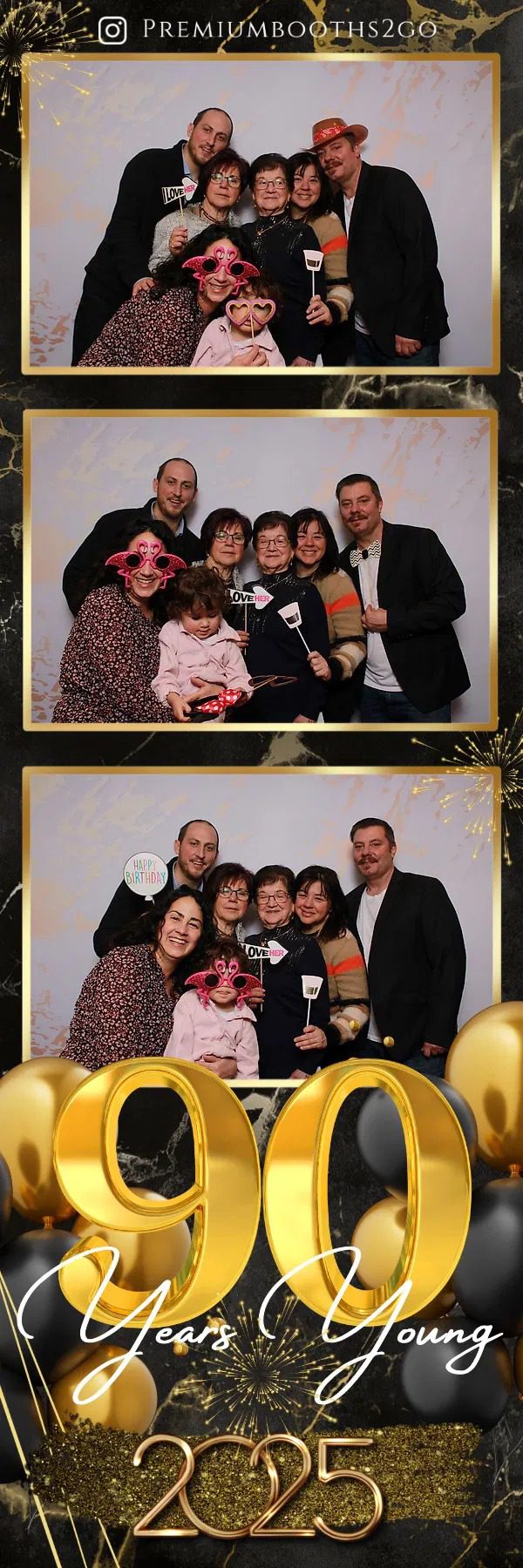 Group of friends posing happily with playful props at a photo booth.