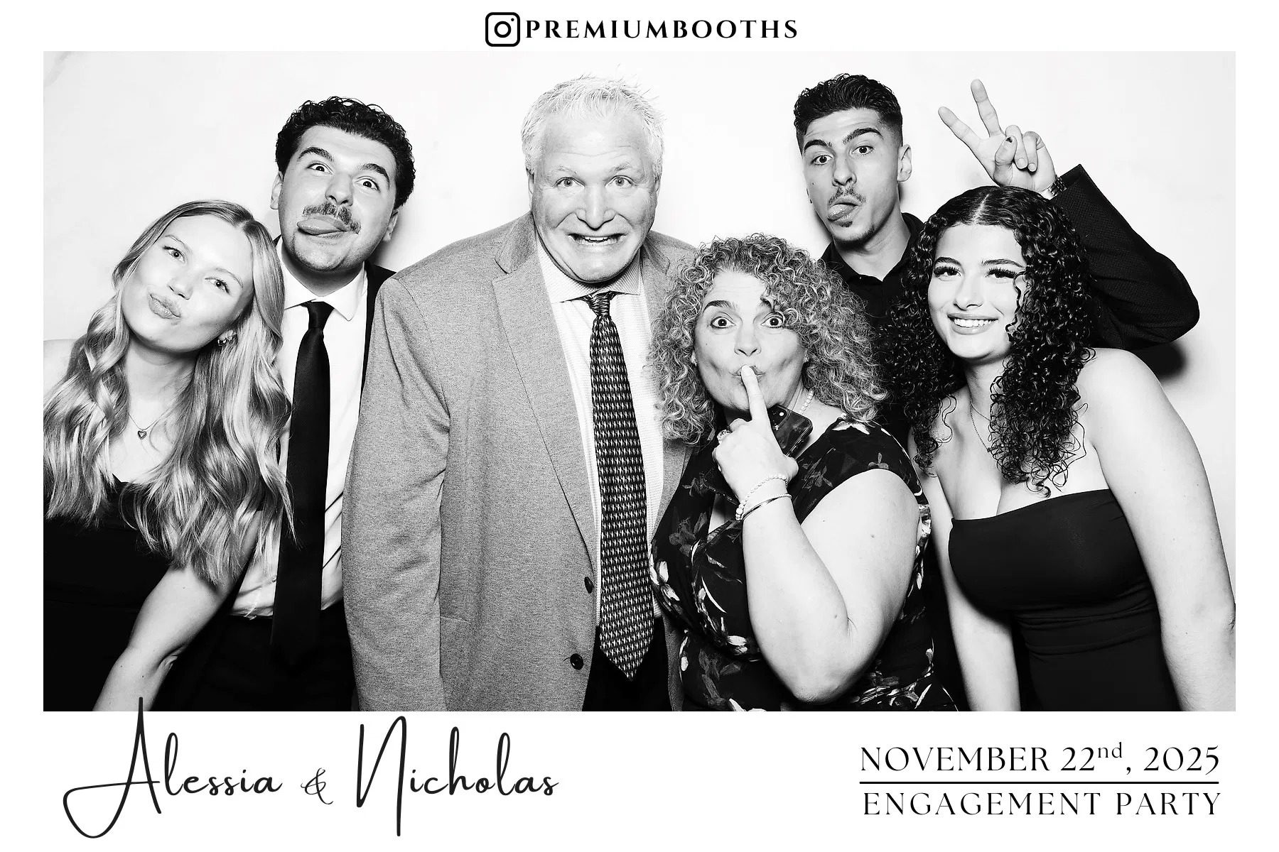 Group of five people smiling at a photo booth.