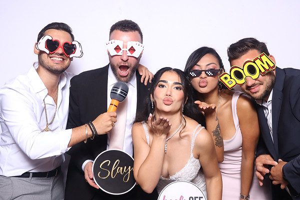 Friends posing with playful party props