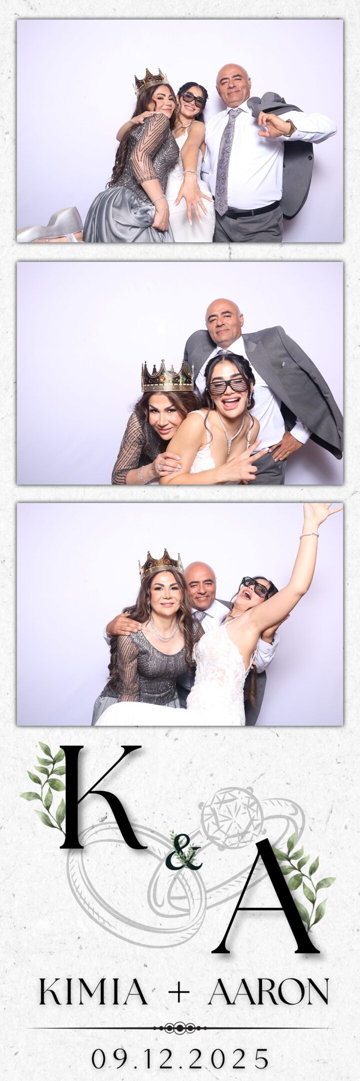 Two women and a man having fun with props at a photo booth.
