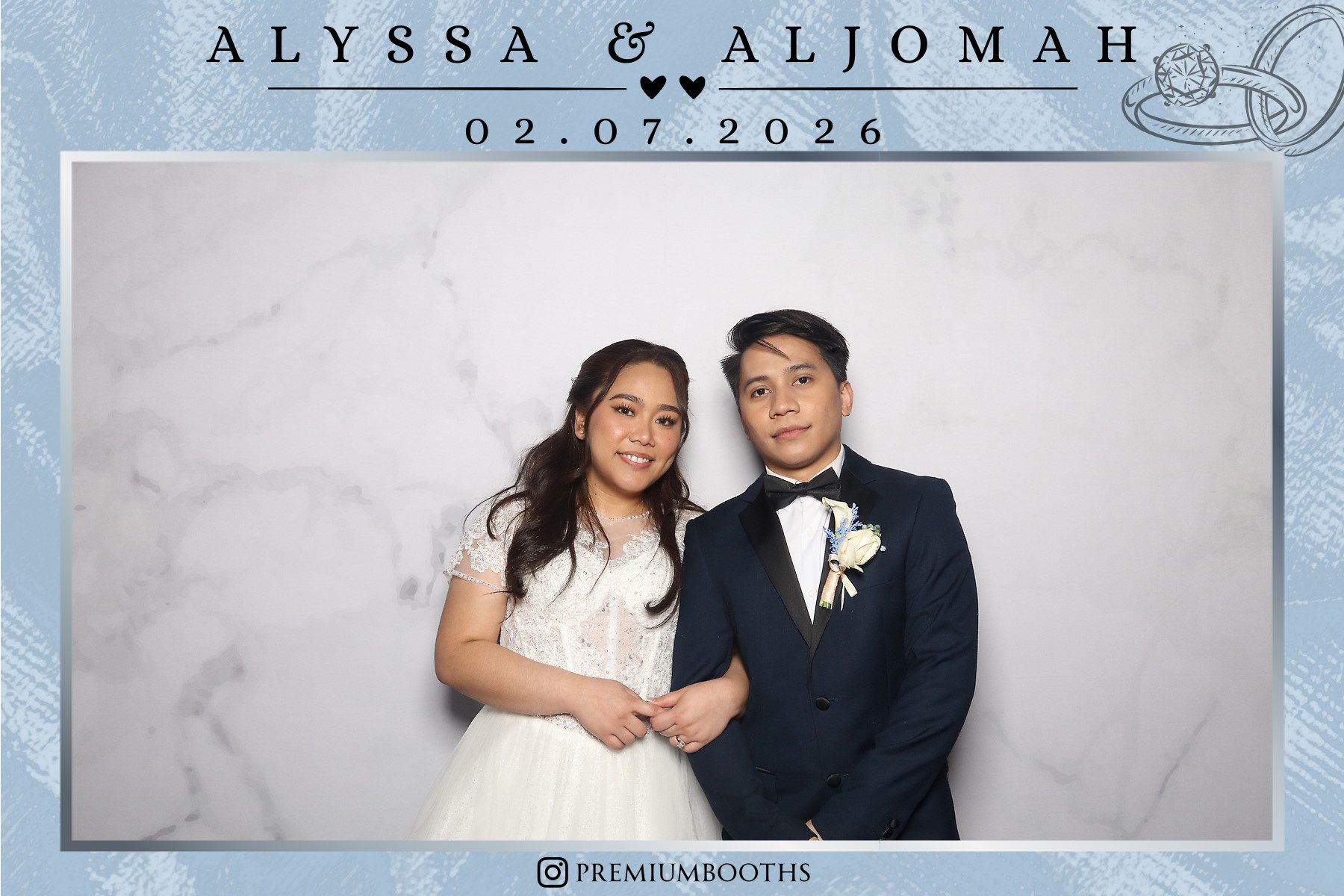 A bride and groom posing happily at their wedding.