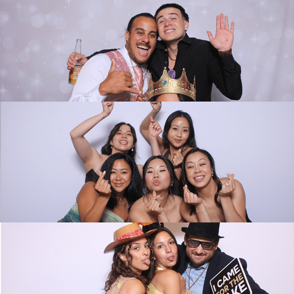 Friends enjoying a fun photo booth session with props and smiles.