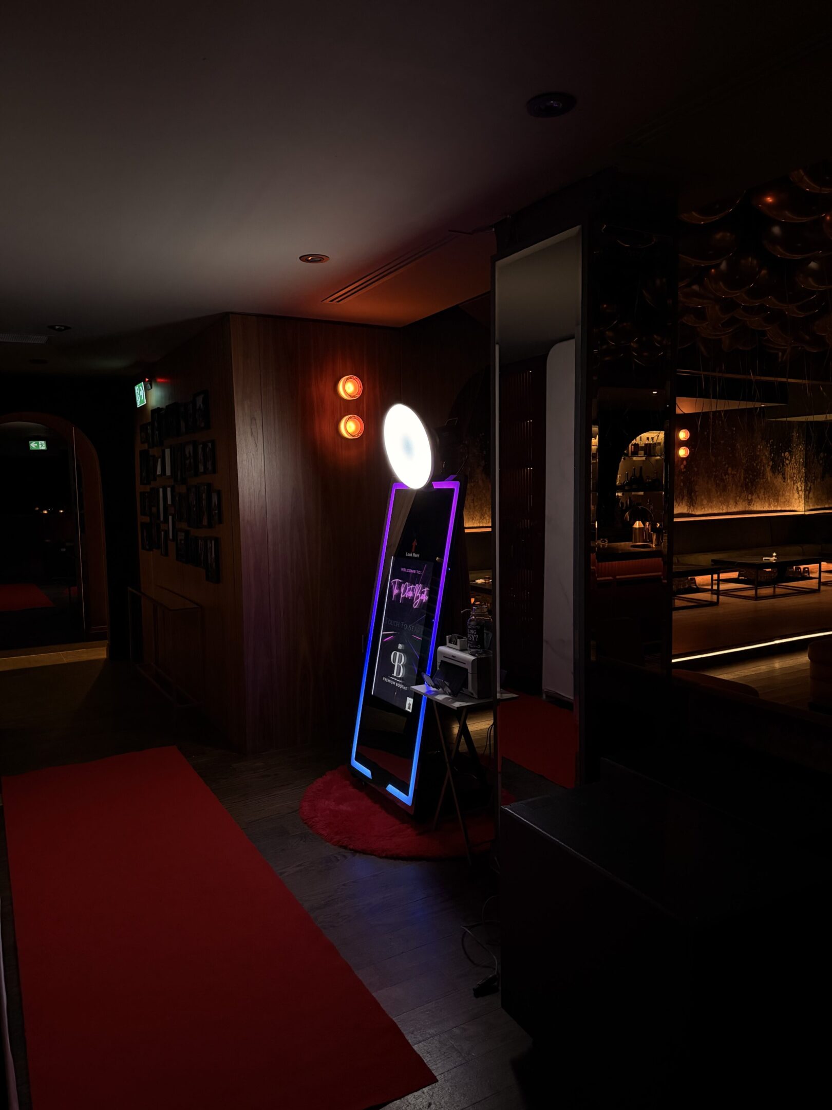 Dimly lit room with a glowing slot machine and reflective surfaces.